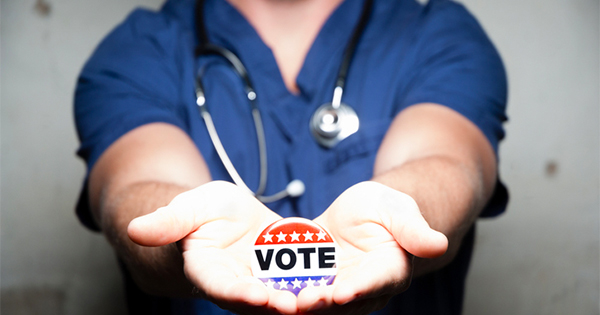doctor holds vote pin