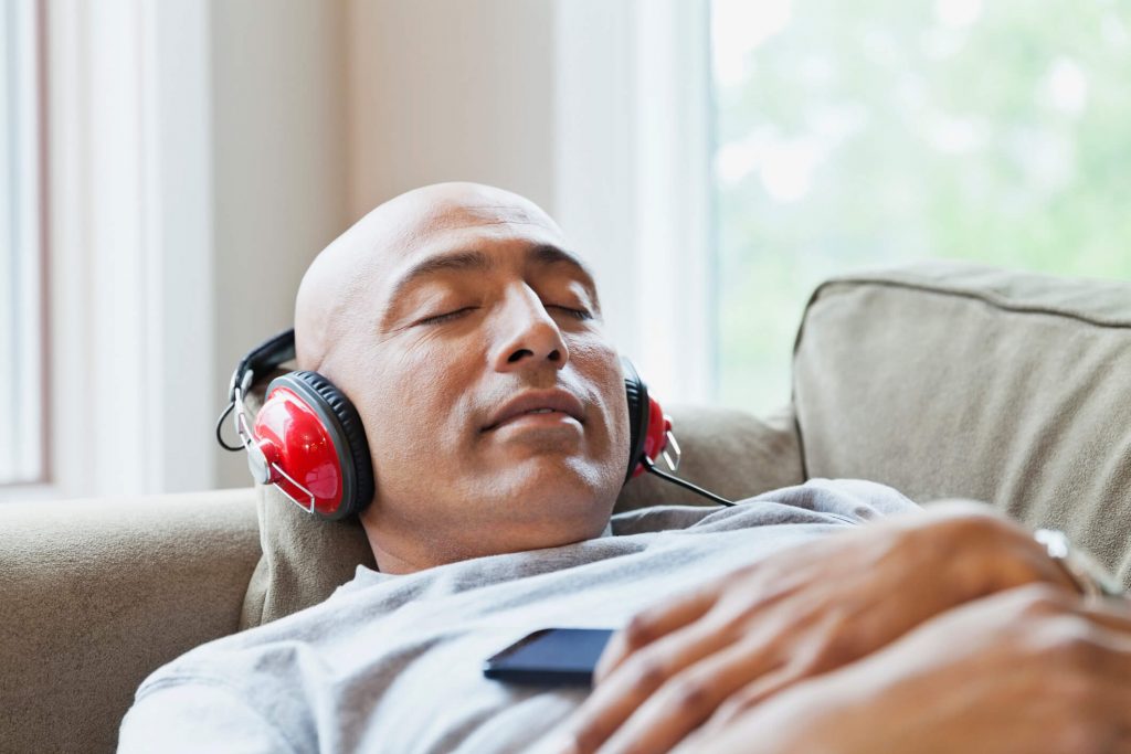 Man listening to podcast, relaxing